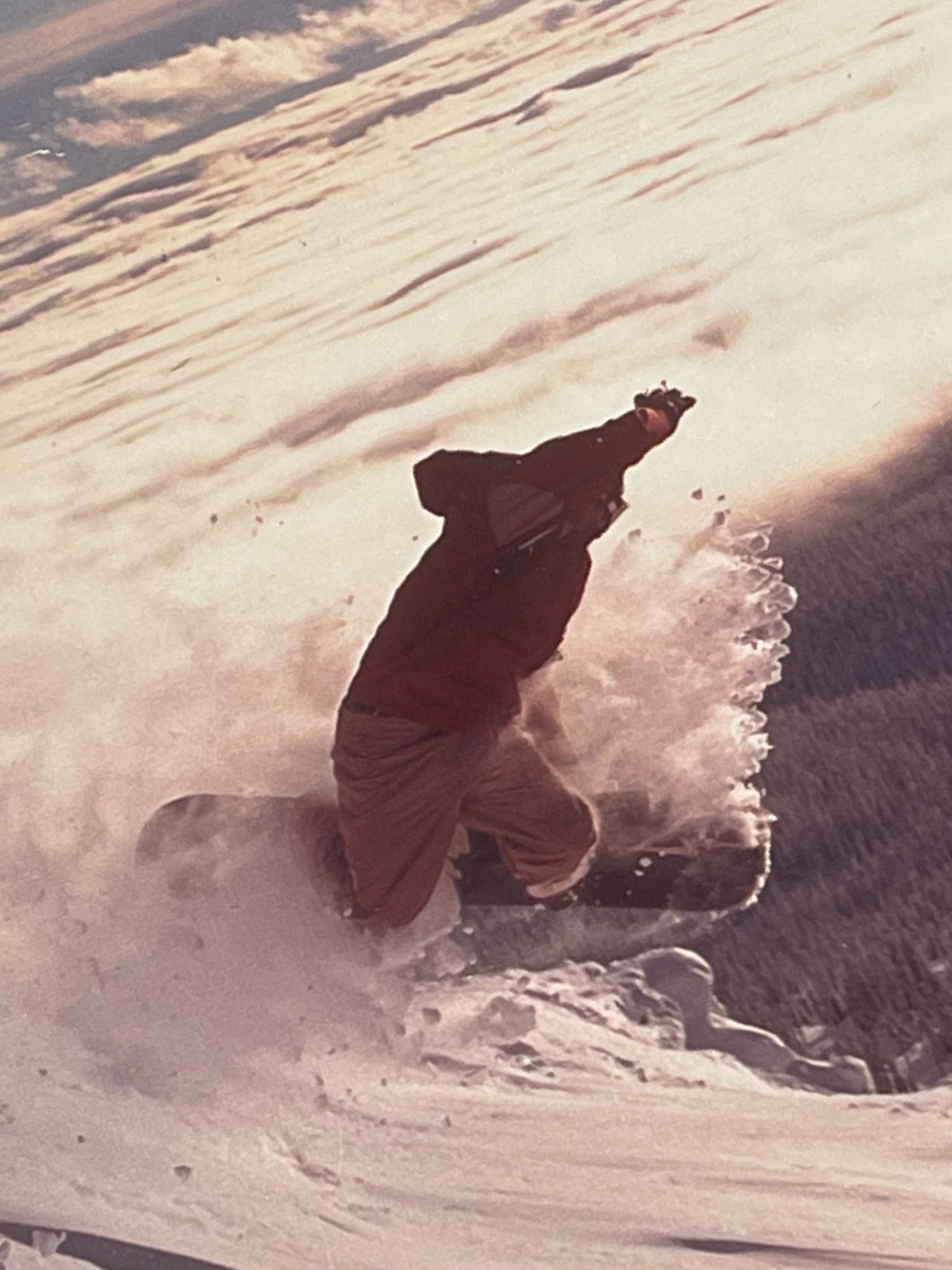 Todd Daniels snowboarding in the mountains